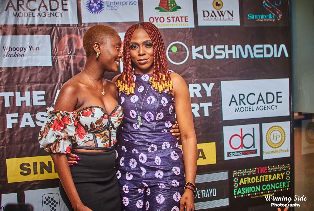 Two guests pose on the red carpet at the AfroLiterary Fashion Concert 1.0 (Photo: Winning Side Photography)